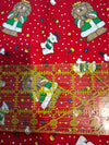 Motivo navideño vintage con leones y osos polares sobre fondo rojo, 100 % algodón ligero. Precio por yarda.