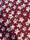 Estrellas vintage con muñecos de nieve sobre fondo rojo. 100 % algodón ligero. Precio por yarda.