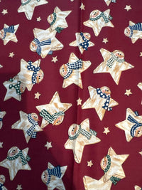 Estrellas vintage con muñecos de nieve sobre fondo rojo. 100 % algodón ligero. Precio por yarda.