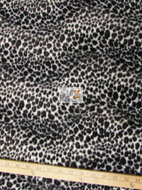 Tejido de felpa de pelo corto con estampado de guepardo en blanco y negro / Se vende por metros