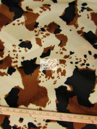 Tejido de felpa de pelo corto con estampado de vaca en colores marrón, negro y blanco roto / Se vende por metros