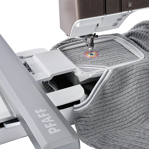 PFAFF embroidery machine stitching a design on fabric