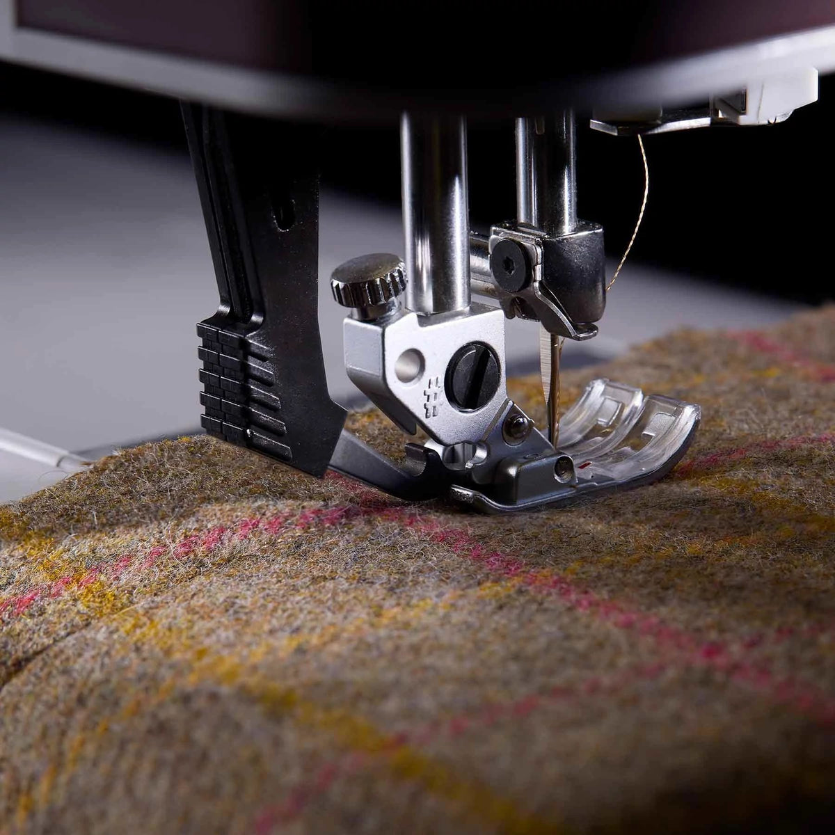 Close view of PFAFF creative expression 750 presser foot and needle stitching textured fabric