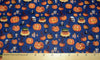 Halloween Spooky Smiling Pumpkin and Skulls on Blue 100% Cotton Fabric